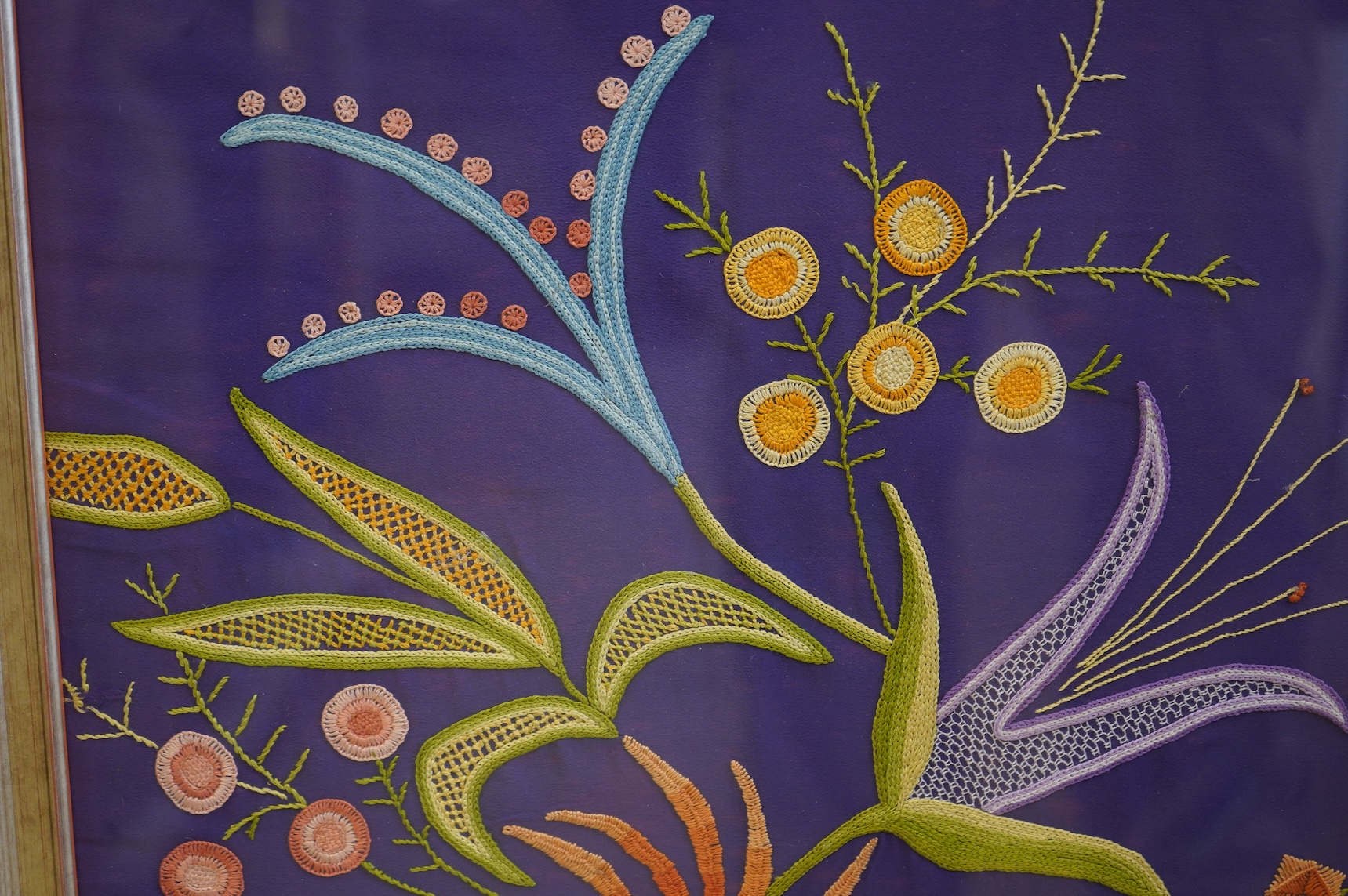 A framed modern silk floral embroidered panel on purple background. 62cm x 63cm